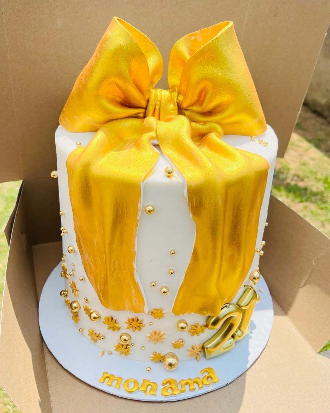 Gold Bow Gift Cake by Baked by Buhlebenkosi
